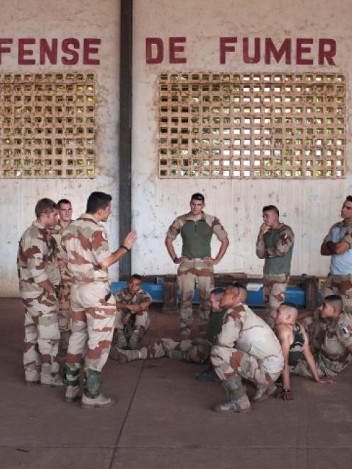 French soldiers listen to instructions in a hangar at the Malian army air base in Bamako. REUTERS...