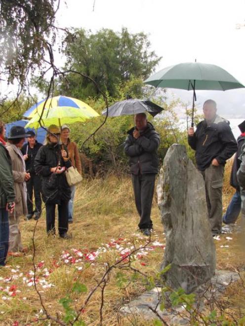 Friends and family gather near Jacks Point on Saturday morning at the unveiling of a stone...