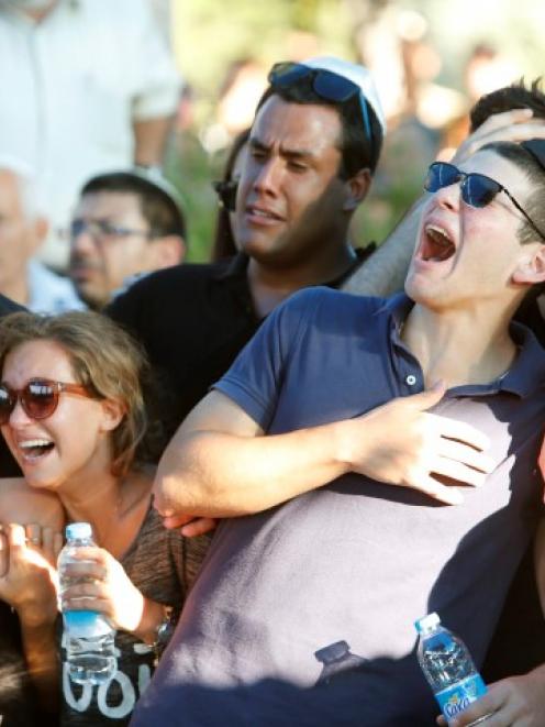 Friends of Israeli soldier Matan Gotlib mourn during his funeral in Rishon Lezion, near Tel Aviv....