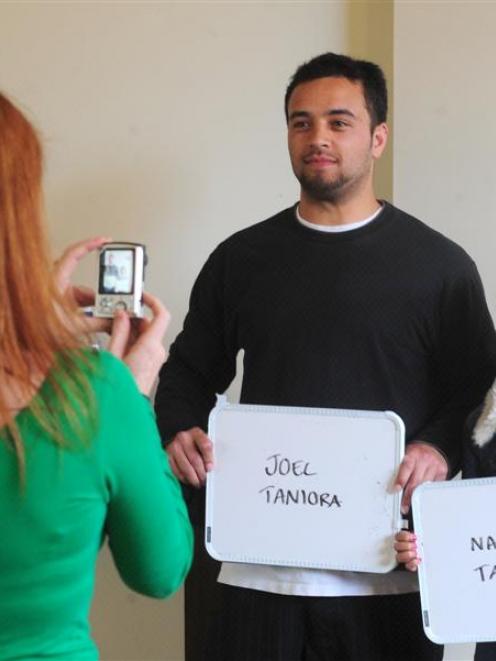 From left, extras casting assistant Jacqui Nairn photographs prospective cast extras Joel and...