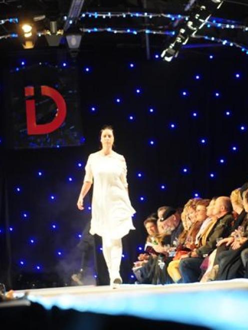 Front-row audience members  watch a model  on the catwalk at the iD Dunedin Fashion Show on...