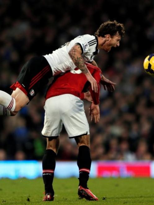 Fulham's Fernando Amorebieta (top) collides with Manchester United's Robin Van Persie. REUTERS...