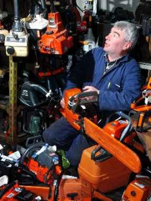 G&J Swann Saw and Mower small motor mechanic John Ferguson sits among a growing pile of returned...