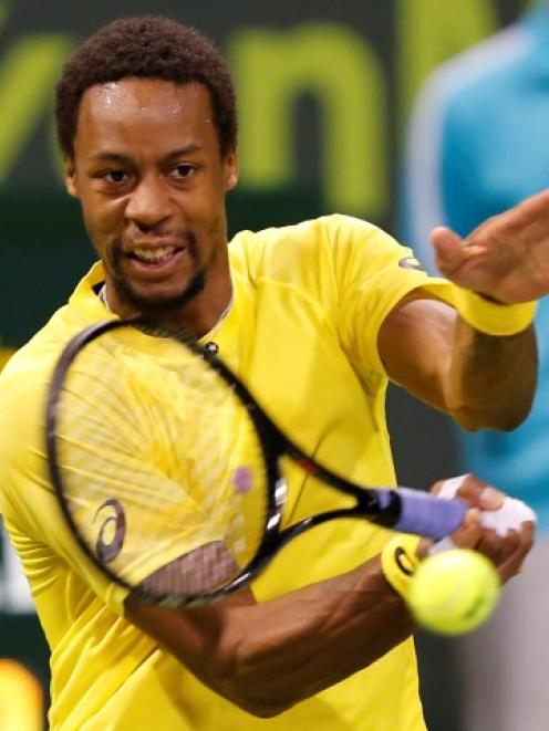 Gael Monfils hits a return against Rafael Nadal during their final match at the Qatar Open....