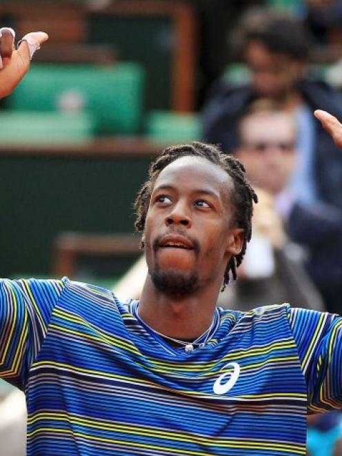 Gael Monfils of France celebrates defeating Ernests Gulbis of Latvia in their men's singles match...