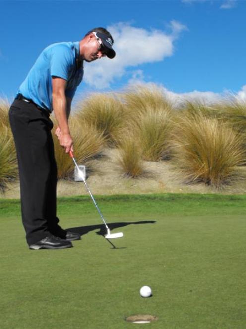 Gareth Paddison, of Wellington, gets in some putting practice before the start tomorrow of the...