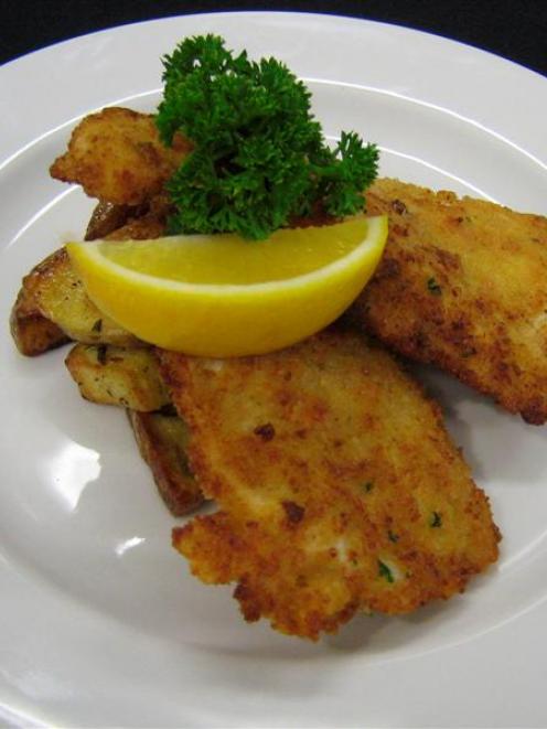 Garlic and rosemary potatoes, served here with crumbed  chicken. Photo supplied.