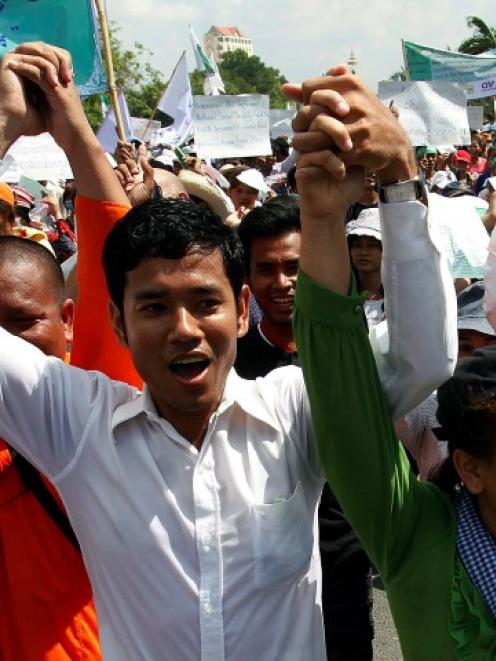 Garment workers shout during a march on the streets to mark International Labor Day in Phnom Penh...