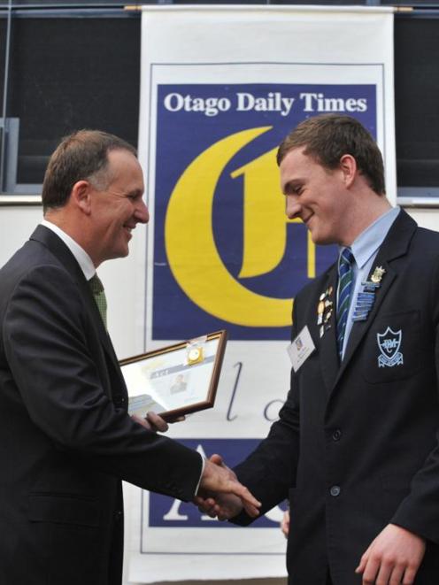 Gavin Stark is presented with his certificate by Prime Minister John Key at the 2013 Class Act...