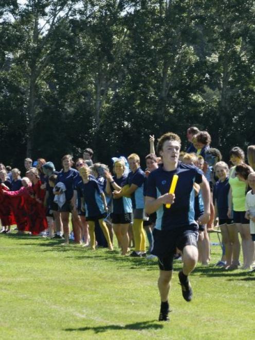 Gavin Stark, of Blue Mountain College, carries the baton in a relay. Supplied photo.