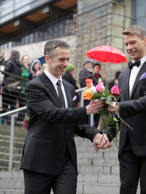 Gay-rights advocate and journalist Dan Savage (L) and Terry Miller sort through roses after...