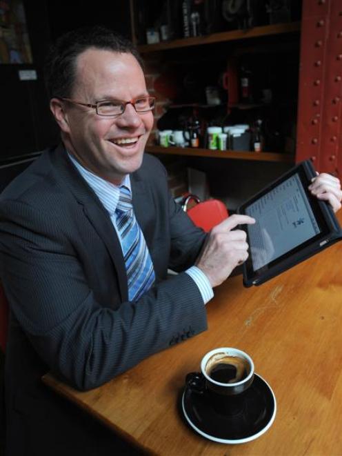 Gen-i client manager Matt Baker demonstrates the versatility of the iPad. Photo by Peter McIntosh.