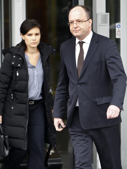 Geneva's Attorney General Olivier Jornot (R) leaves a HSBC Swiss branch of the bank in Geneva...