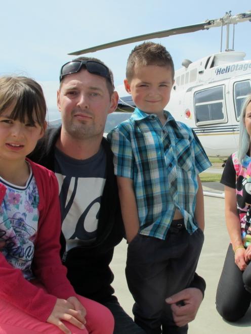 Geoff and Steph Mulder and  their children, Carerra and Ryker, prepare for their helicopter...