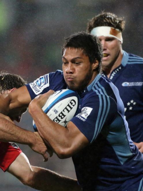 George Moala of the Blues runs into George Whitelock of the Crusaders. (Photo by Joseph Johnson...