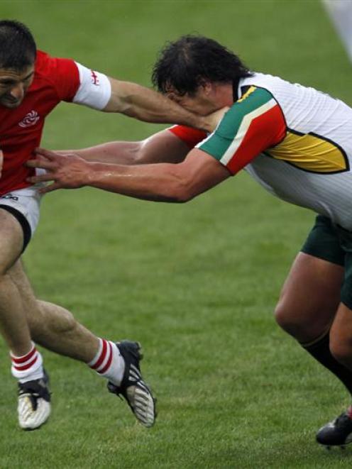 Georgia's Malkhaz Urjukashvili (left) fends off South African Kings' Clint Newland during an IRB...