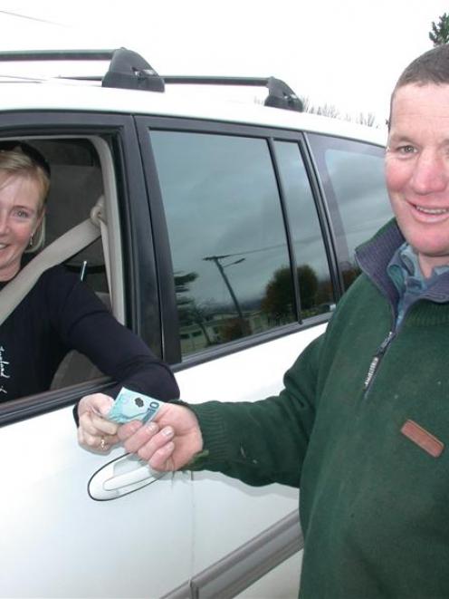 Georgina Murray, of Queenstown, makes a donation for Omarama School to Richard Subtil, of Omarama...