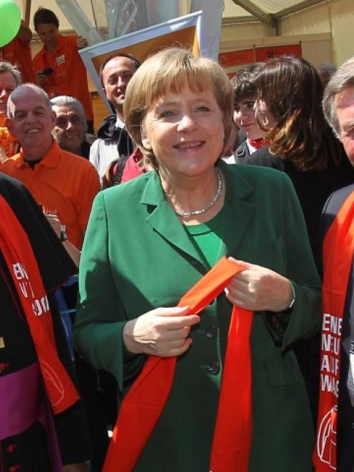 German Chancellor Angela Merkel (C) talks with Archbishop Robert Zollitsch (L) and Lois Glueck (R...