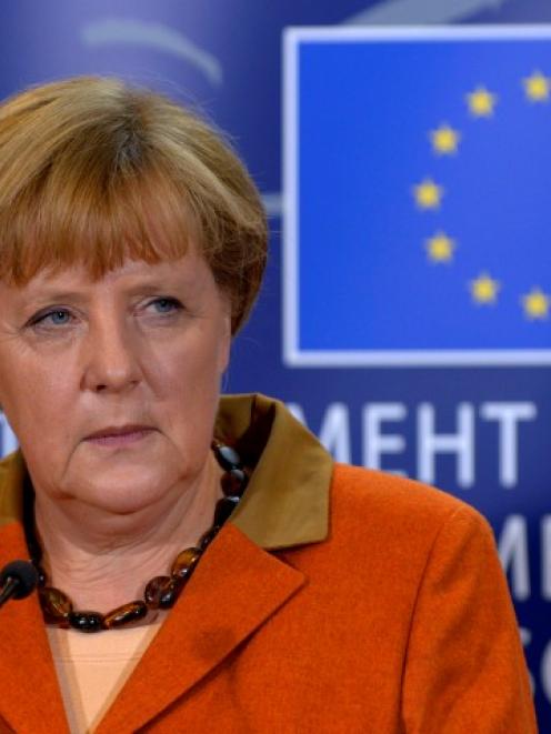 German Chancellor Angela Merkel holds a news conference after addressing the political groups at...