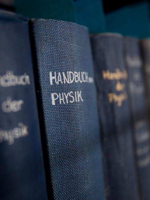 German encyclopedias of physics from the 1920s are loaded onto cards at the physics library at...