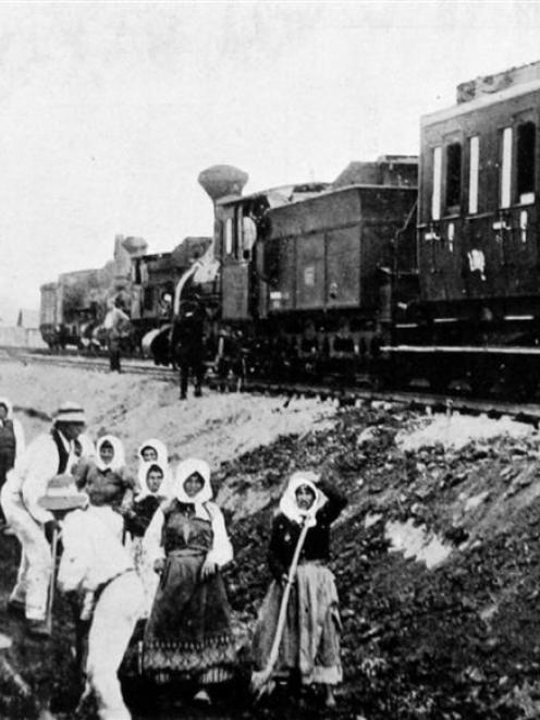 German soldiers watch from a train as they supervise Polish women, who are required to work on...