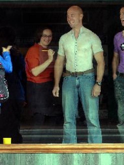 German tourists Jurgen and Edith Kopp, of Heidelberg, react as artist Elizabeth Dalton body...