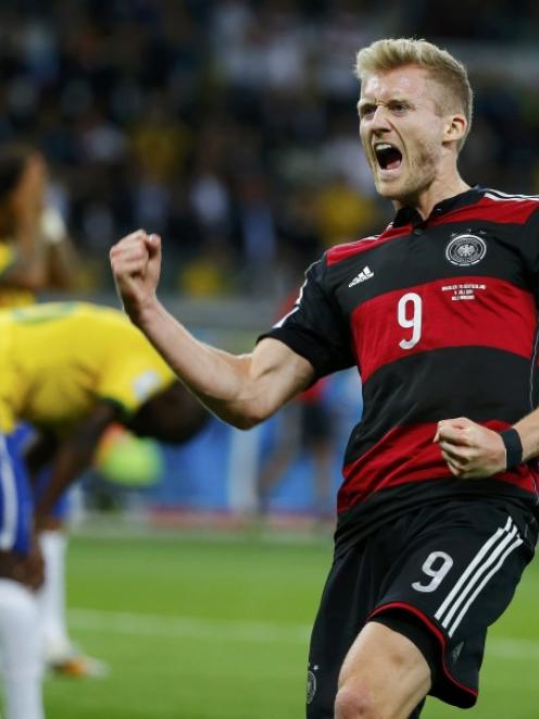 Germany's Andre Schuerrle celebrates scoring his team's sixth goal against Brazil during their...