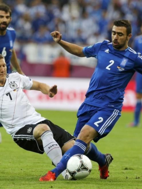 Germany's Bastian Schweinsteiger, left, will be on most shortlists for the team of the tournament...