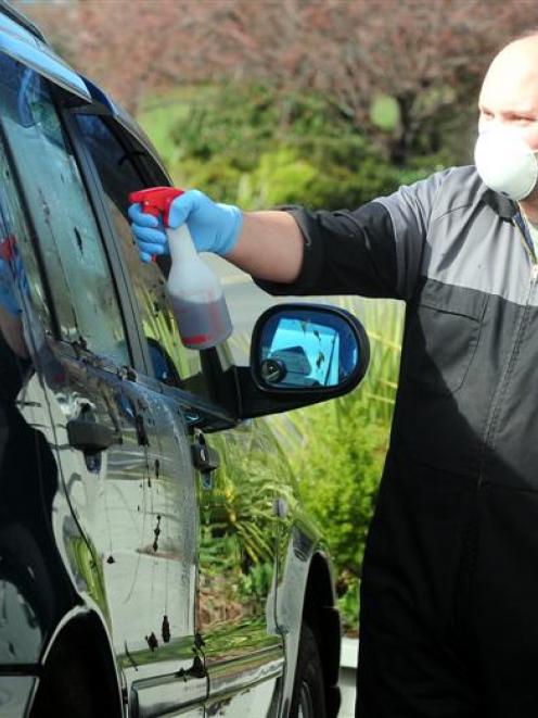 Gilmour Motors car groomer Daniel Mosley cleans faeces off a car in the company's Princes St yard...