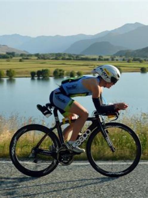 Gina Crawford, of Wanaka, rides  past Paddock Bay on her way to second place  in the Challenge...