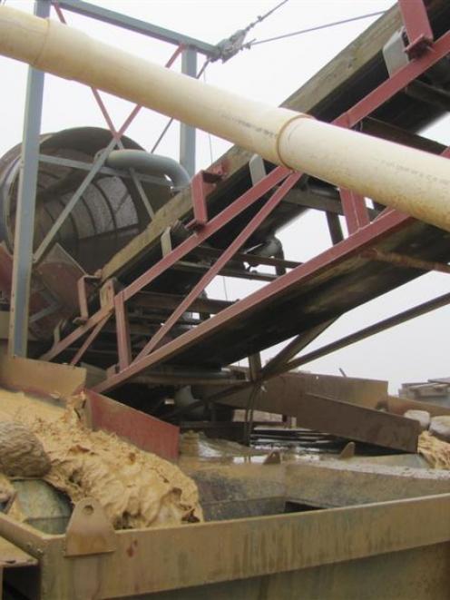 Gold being sieved from larger material at one of Glass Earth Gold's recovery units, pictured ...