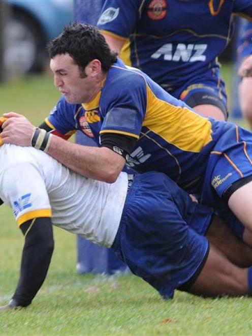 Gold second five-eighth Lex Kaleca scores under the tackle of Blake Korteweg in the Otago trial...