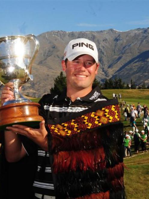 American Alex Prugh holds the trophy after winning the New Zealand Open at the Hills yesterday....