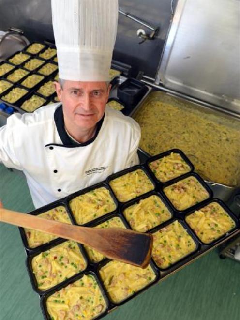 Gordon McKenzie prepares trays of chicken pasta bake ready to be frozen and dispatched to...