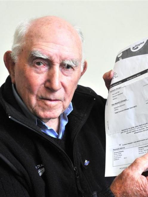 Gordon Ralph, of Ocean Grove, holds up a bill that someone allegedly opened before faking a reply...