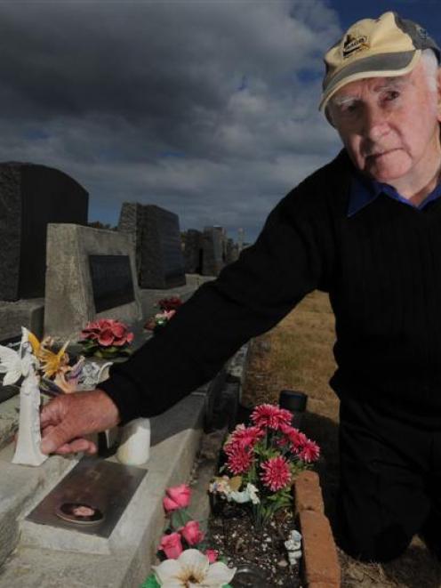 Gordon Ralph with the remaining angel at the grave of his three daughters in the Andersons Bay...