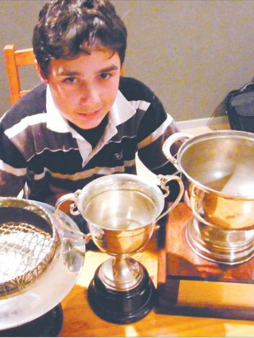 Gore High School pupil and golfer Sam Brinsdon (13), of Gore, with three of the trophies he has...