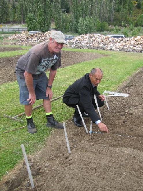 Governor-General Sir Jerry Mateparae plants seeds with volunteer gardener Frank Thompson, of...