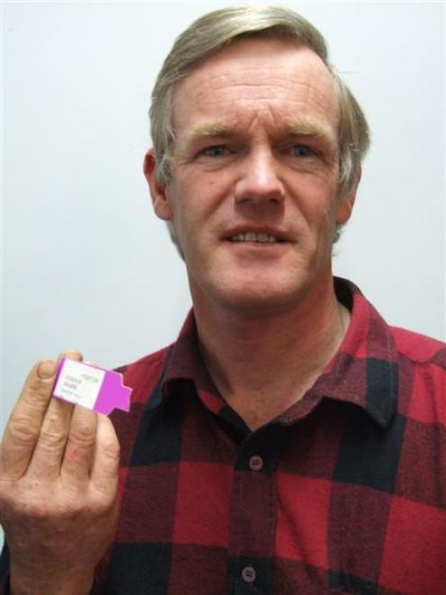 Oamaru man Graeme Simpson with the bracelet from his last hospital visit which he carries in his...