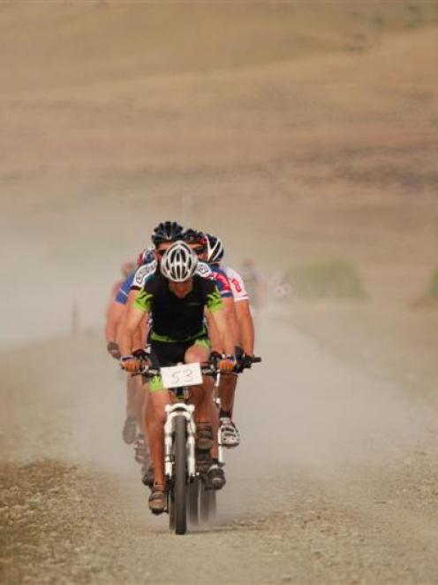 Grafting into a strong wind, mountain bikers compete in last year's Dusky Trail event, one of the...