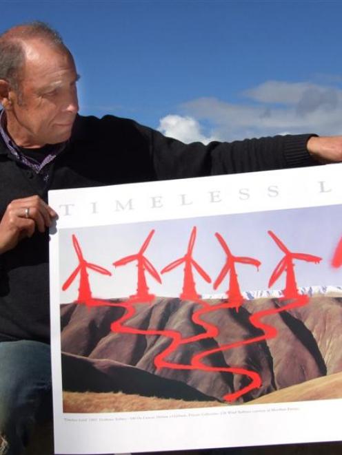 Grahame Sydney with his defaced copy of his well known painting A Timeless Land. Photo by Diane...