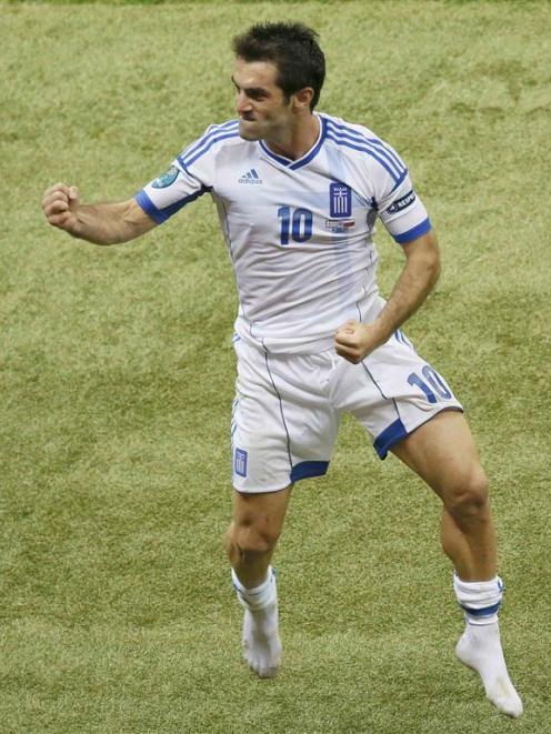 Greece's Giorgos Karagounis celebrates victory against Russia. REUTERS/Leonhard Foeger