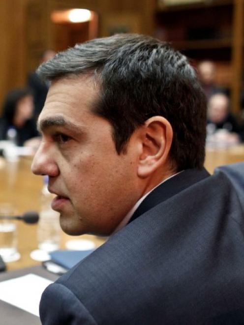Greek Prime Minister Alexis Tsipras attends a cabinet meeting at the parliament building in...