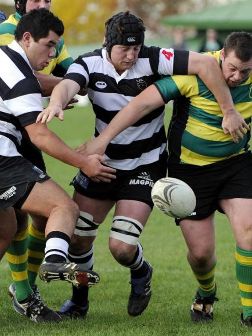 Green Island prop Simon McCarthy (right) competes for possession with Southern forwards Wesley...