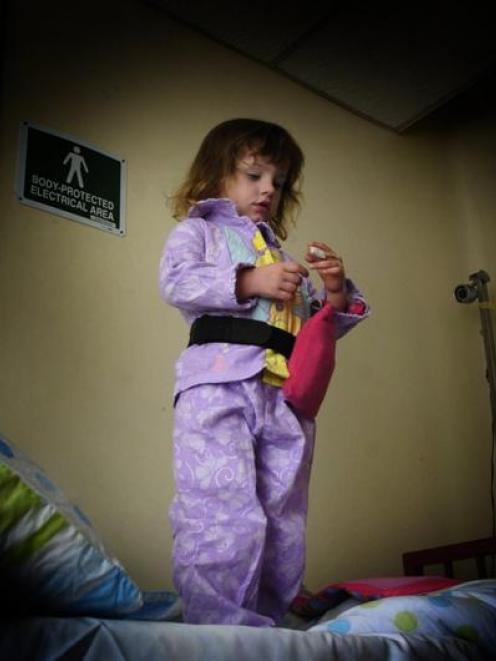Greer Ferguson (2) checks out the "glow worm" monitor on her finger. Greer has been registered...