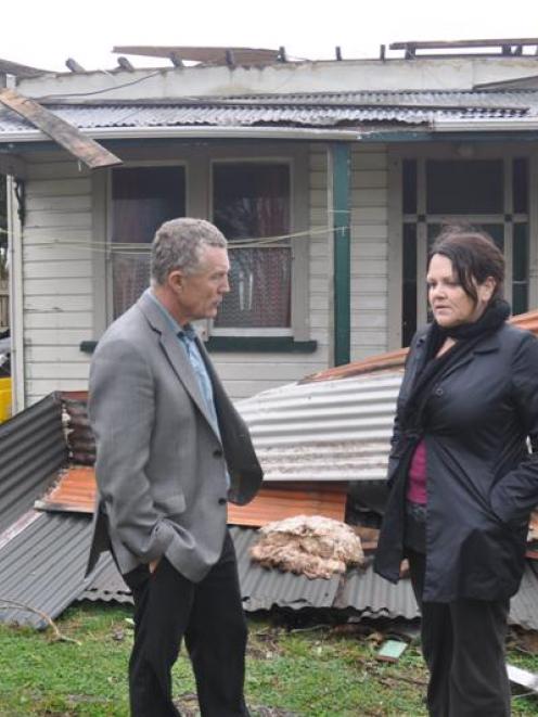 Grey District Mayor Tony Kokshoorn surveys Sue Twist's Cobden  home, among the ruins of her roof...