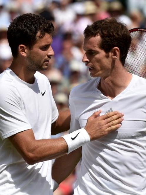 Grigor Dimitrov (L) speaks to Andy Murray after defeating him in their men's singles quarterfinal...