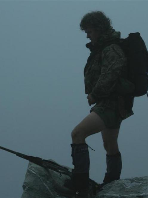 Ground hunter Shaun Moloney, in Whataroa, in Westland, pauses in thick mist while trophy hunting....