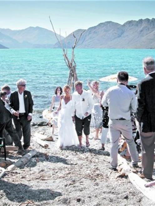 Guests wish Catherine Lyness and Nigel Anderson well after they were married on a Lake Wanaka...