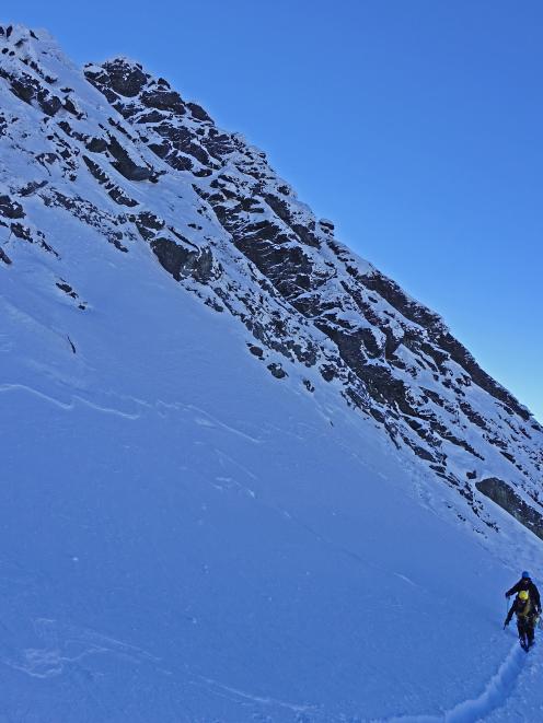 Guide Cam Walker  (front) and client Ben McDonald, of Queensland, traverse the eastern face of...